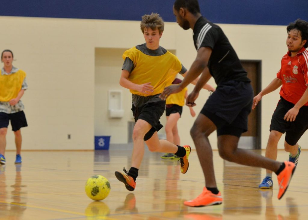 Students playing intramural soccer at the Wellness Center
