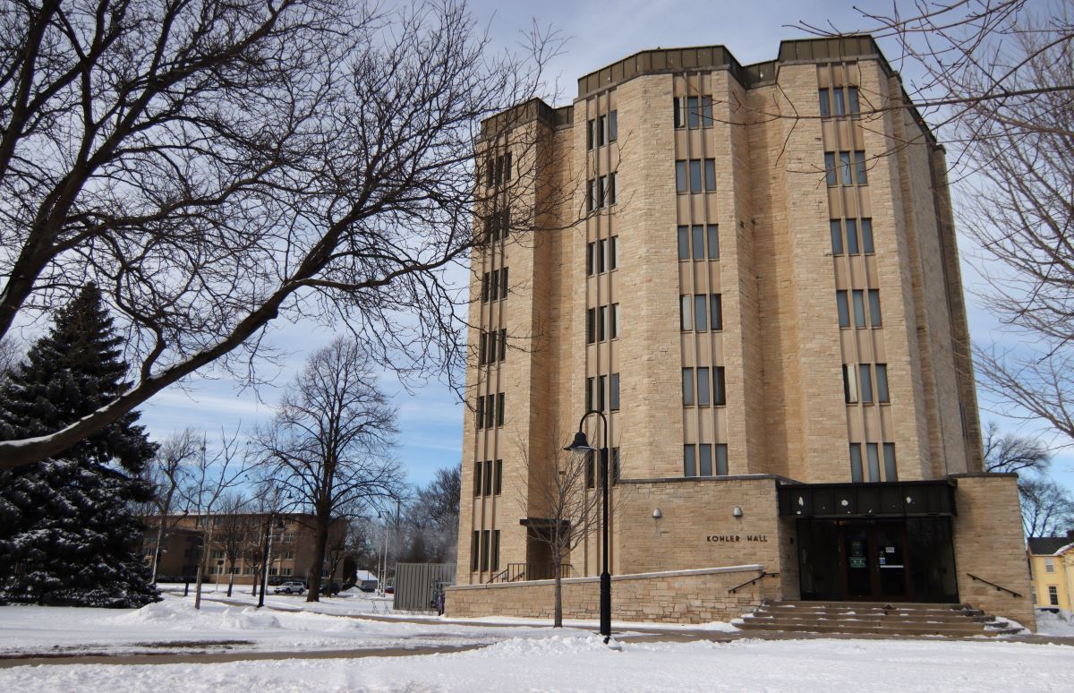 Kohler Hall surrounded by leafless trees and snow
