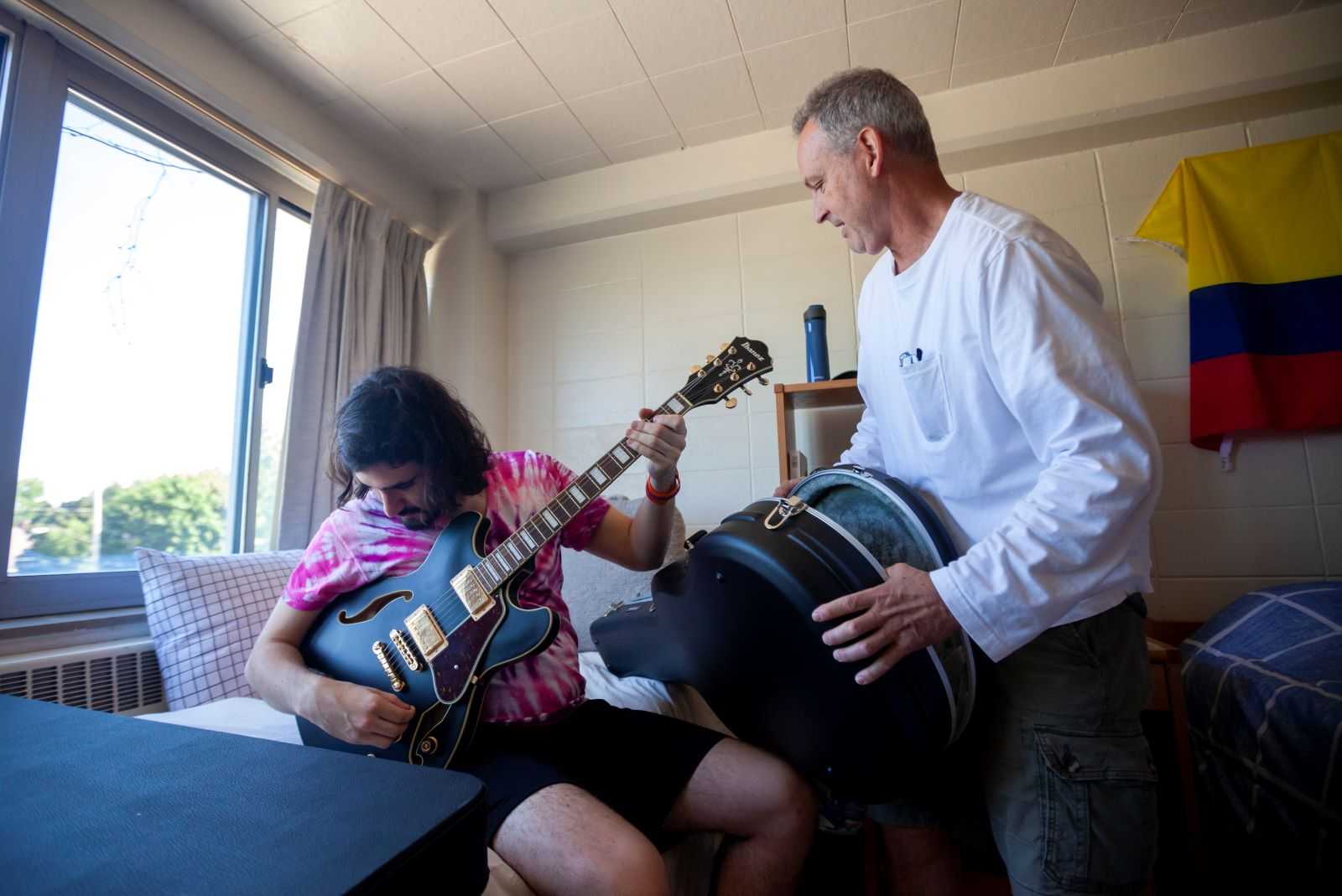 Isaac Corby, a first-year student, takes out a guitar with his father, Brian Corby, during move-in.