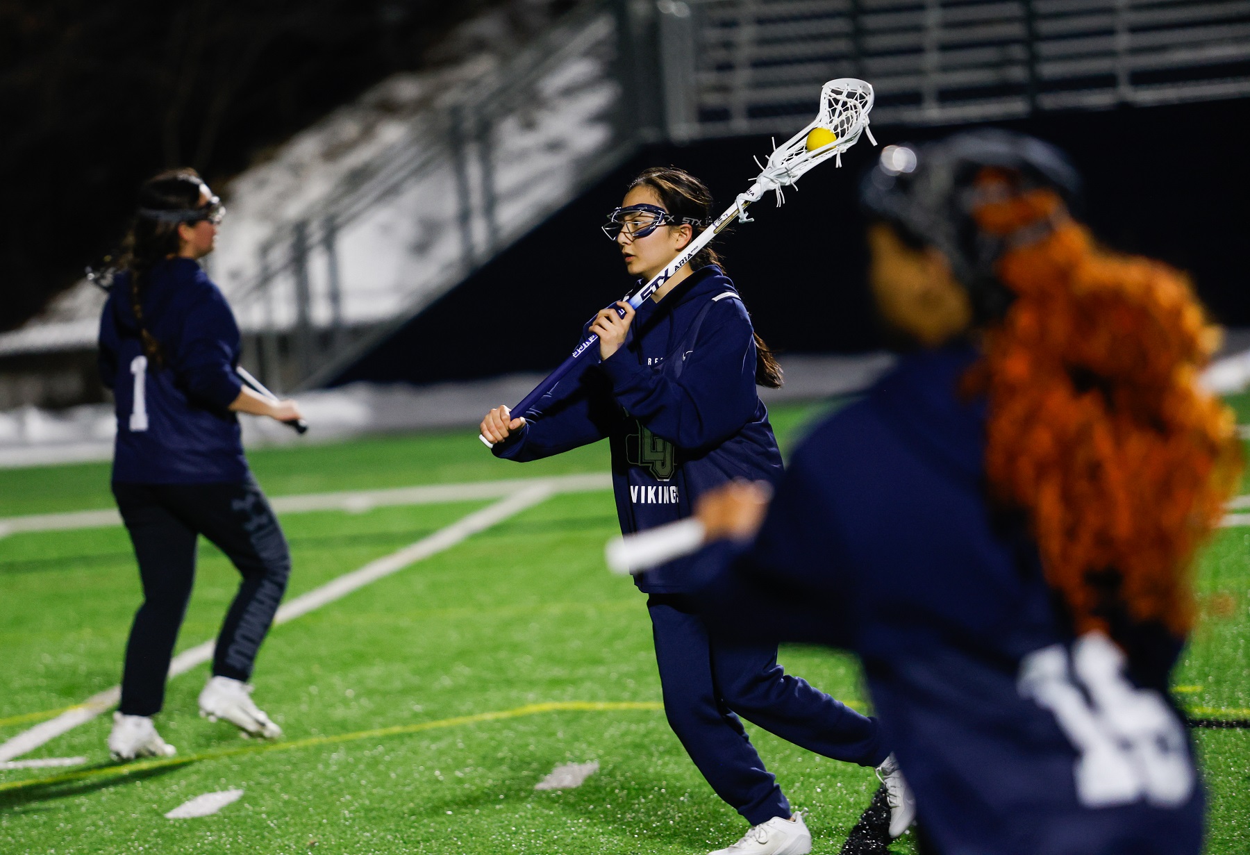 Sena Hasegawa handles the ball in practice for the women's lacrosse team.