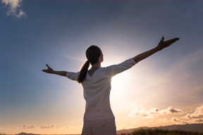 Woman with her hands facing the sky