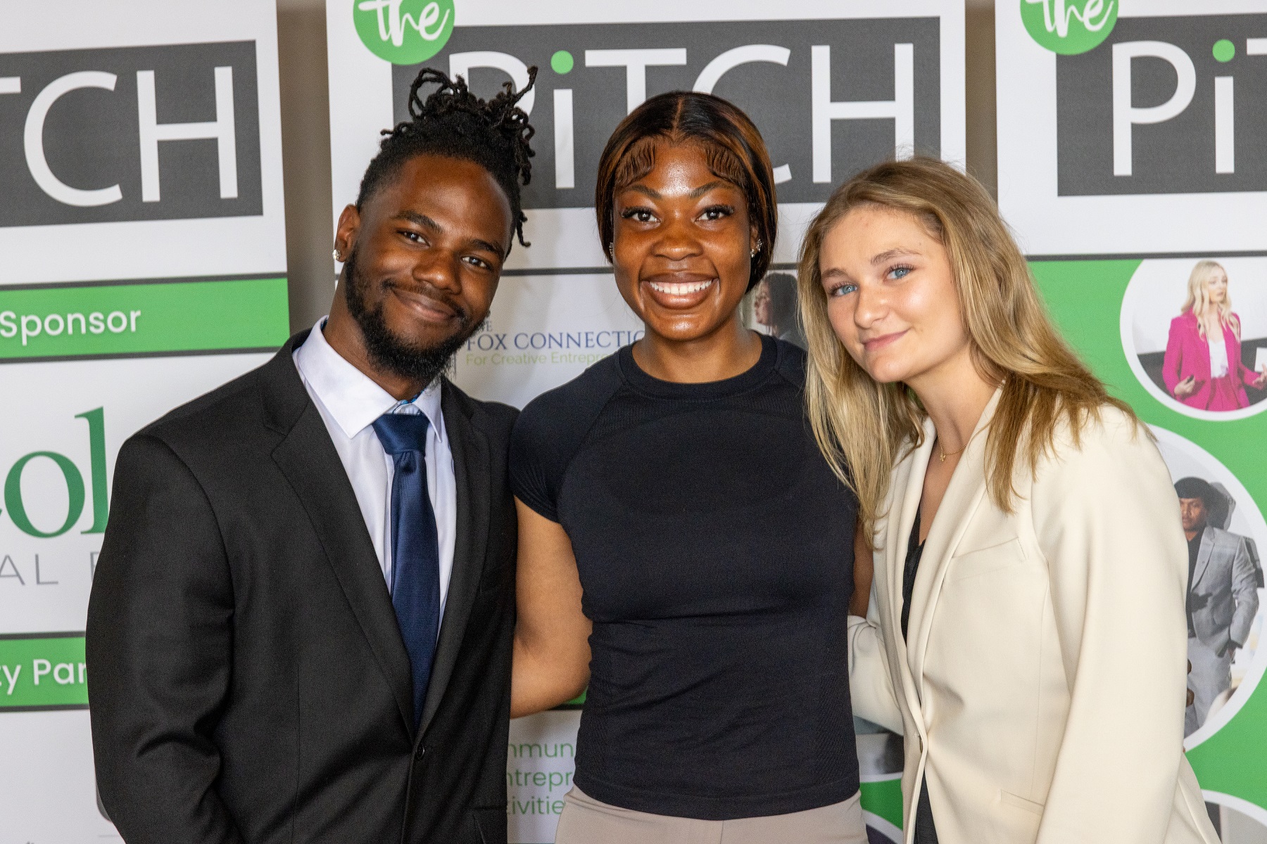 Faith Onukaogu (center) poses for a photo at The Pitch with Lawrence's Sheldon Watson and Emma Perry.