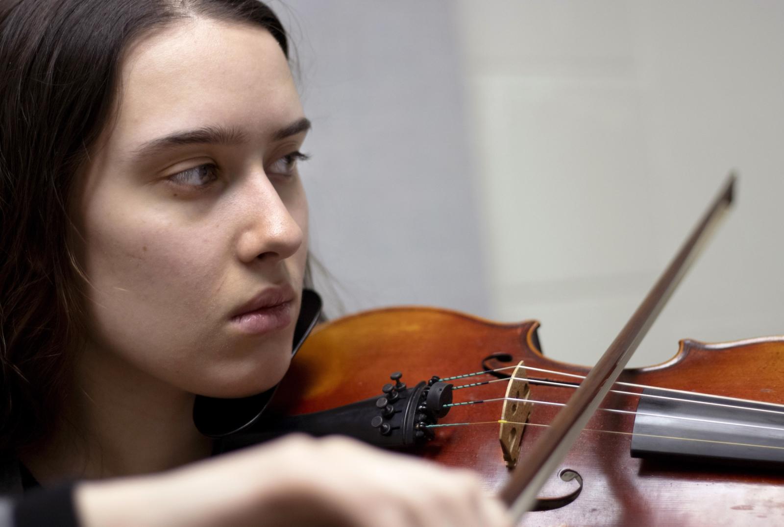 Rehanna Rexroat '20 plays the violin during a recent rehearsal session in Shattuck Hall.