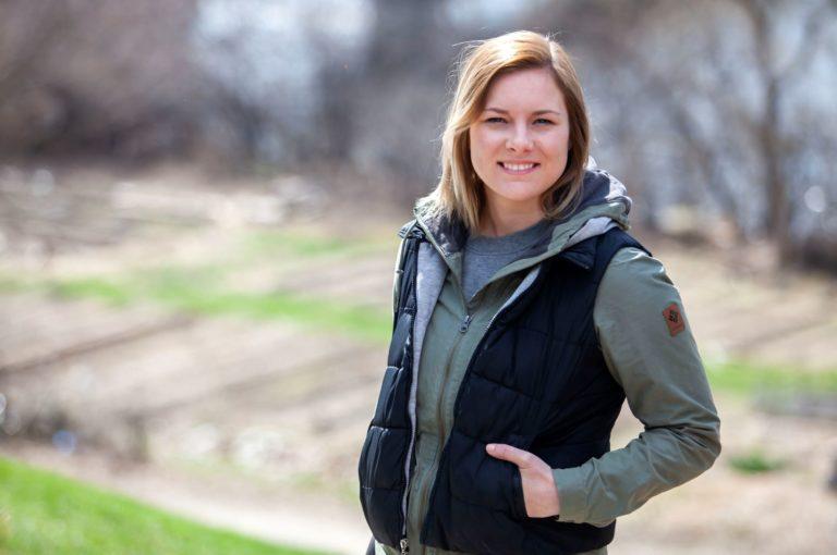 Kelsey McCormick poses for a photo overlooking the SLUG garden.