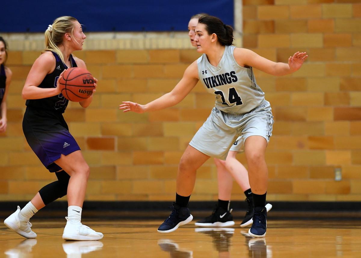Student Karina Herrera in the middle of a basketball game 