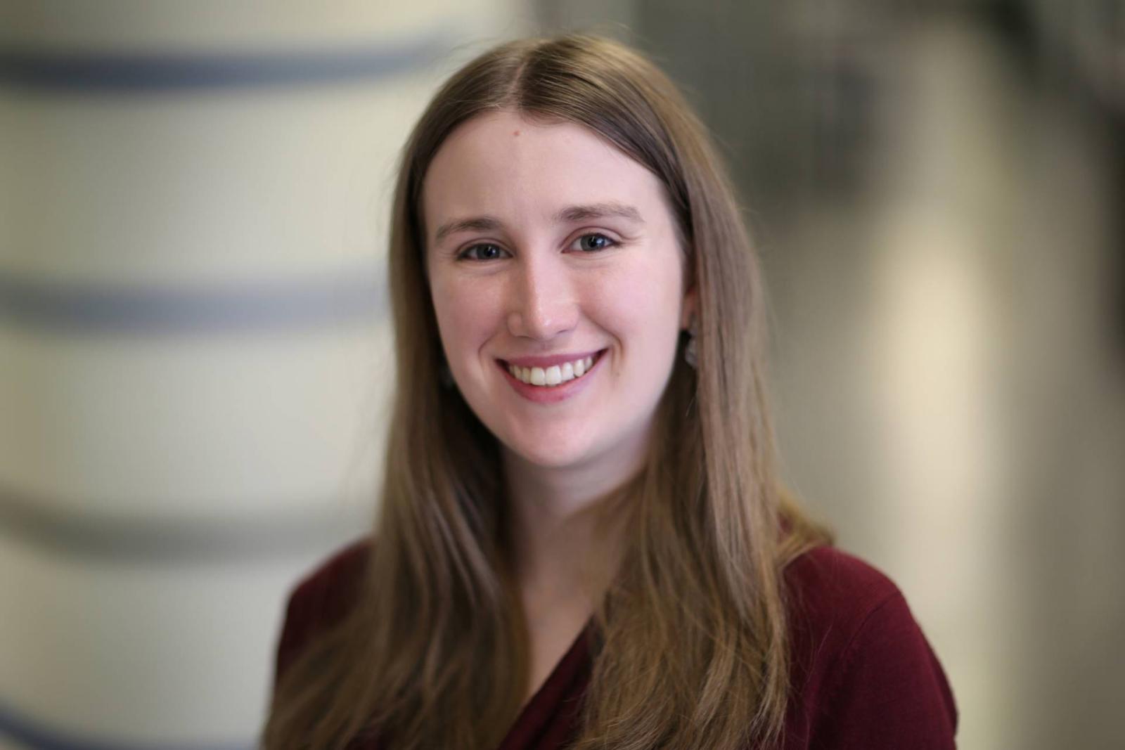 Headshot of Katherine Meckel against a blurred background.