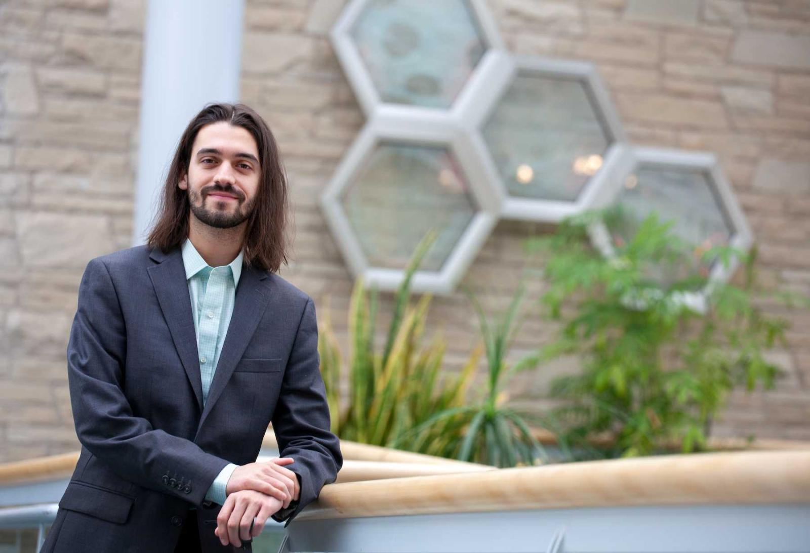 Gaston Kaisin poses for a photo in front of Youngchild Hall.