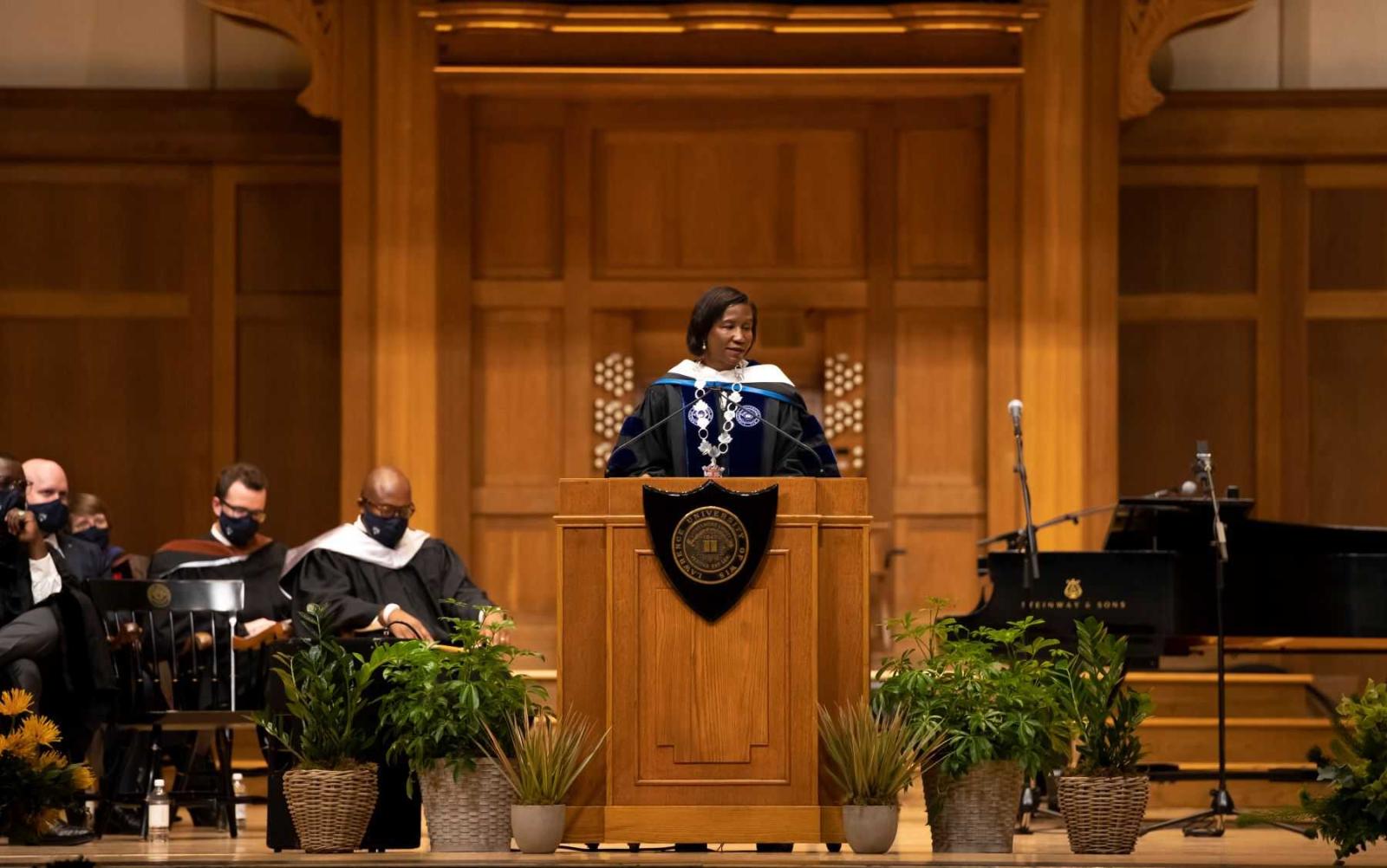 President Laurie Carter speaks at the podium on the stage of Memorial Chapel.