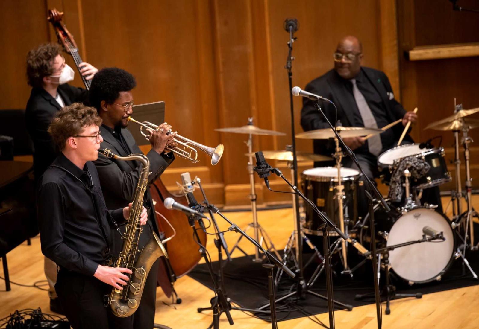 Alex Rothstein, Earl Simons, Aaron Brenton, and Carl Allen perform Blues March during the inauguration ceremony.