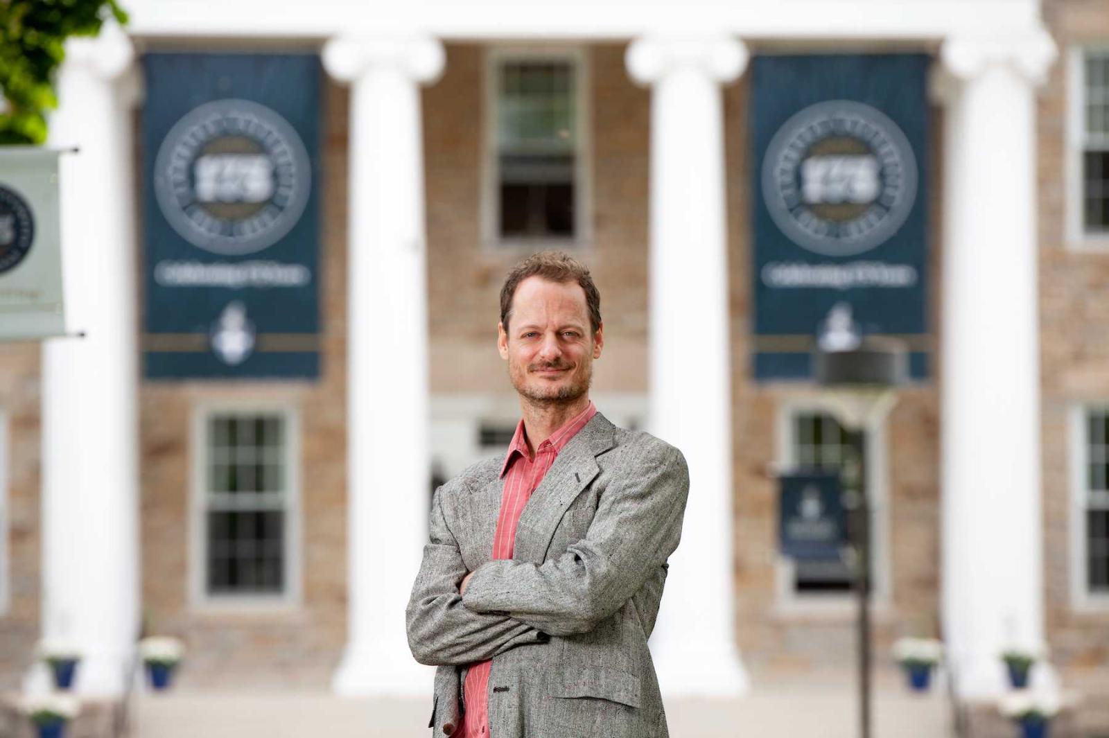 Austin Segrest folds his arms as he poses in front of Main Hall.