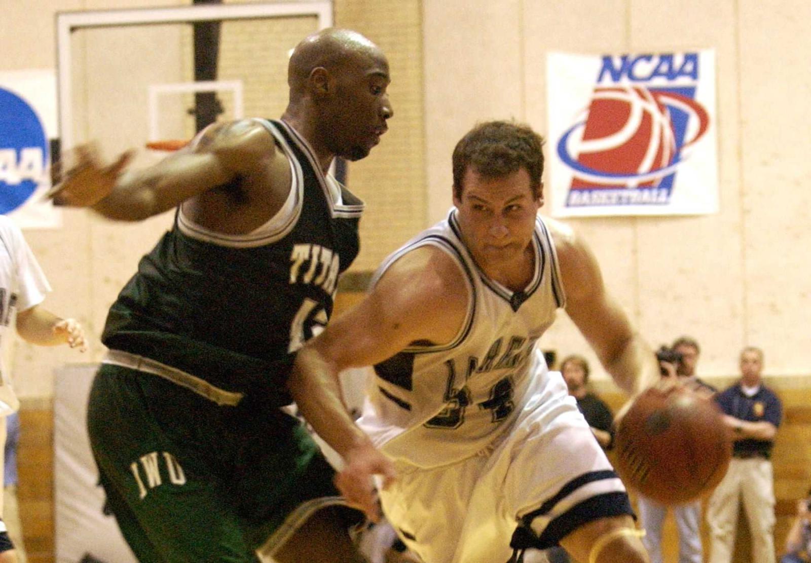 Chris Braier drives to the basket in a Lawrence basketball game.