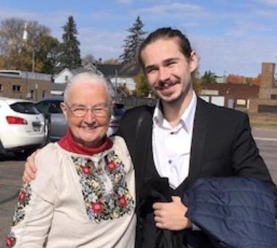 Mary Deckert shares a moment with 波丹Tataryn. She's wearing a traditional Ukrainian blouse.