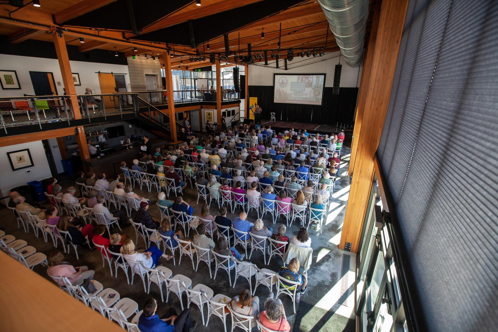An audience looks on at Poplar Hall as the Appleton documentary is shown.