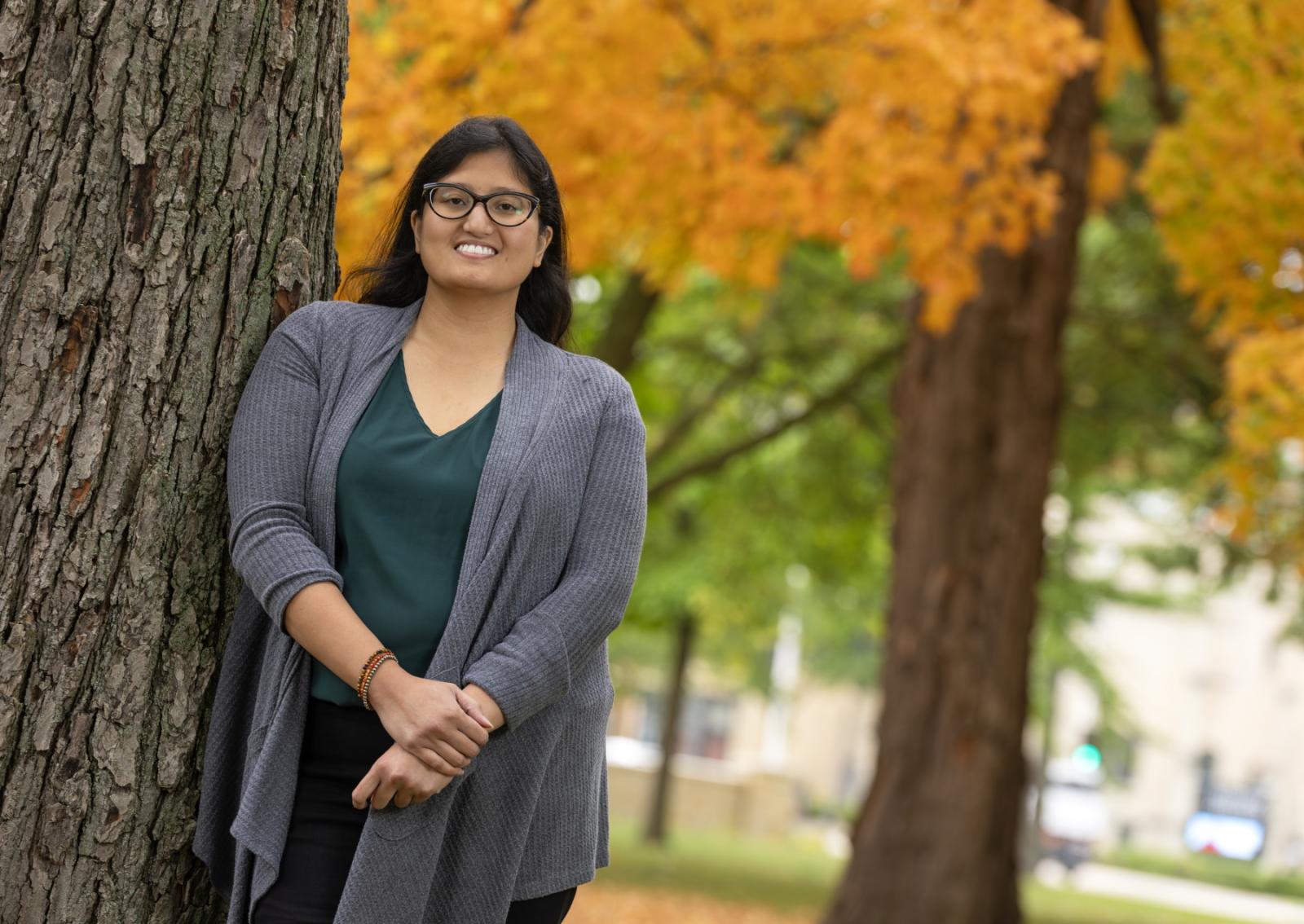 Marcy Quiason poses for a portrait amid fall colors on Main Hall Green.