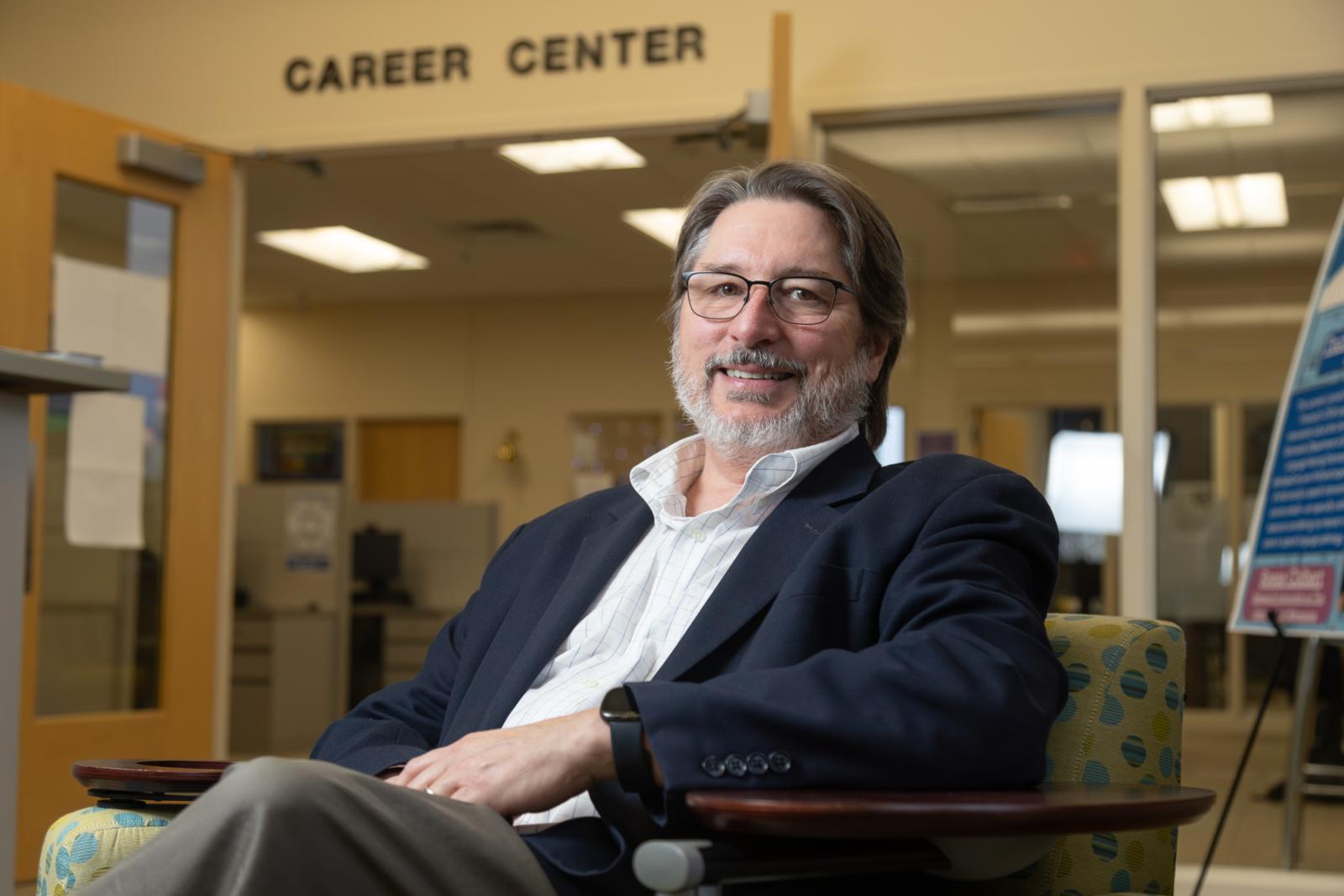 Kevin Gaw poses for a photo while sitting in the Career Center.
