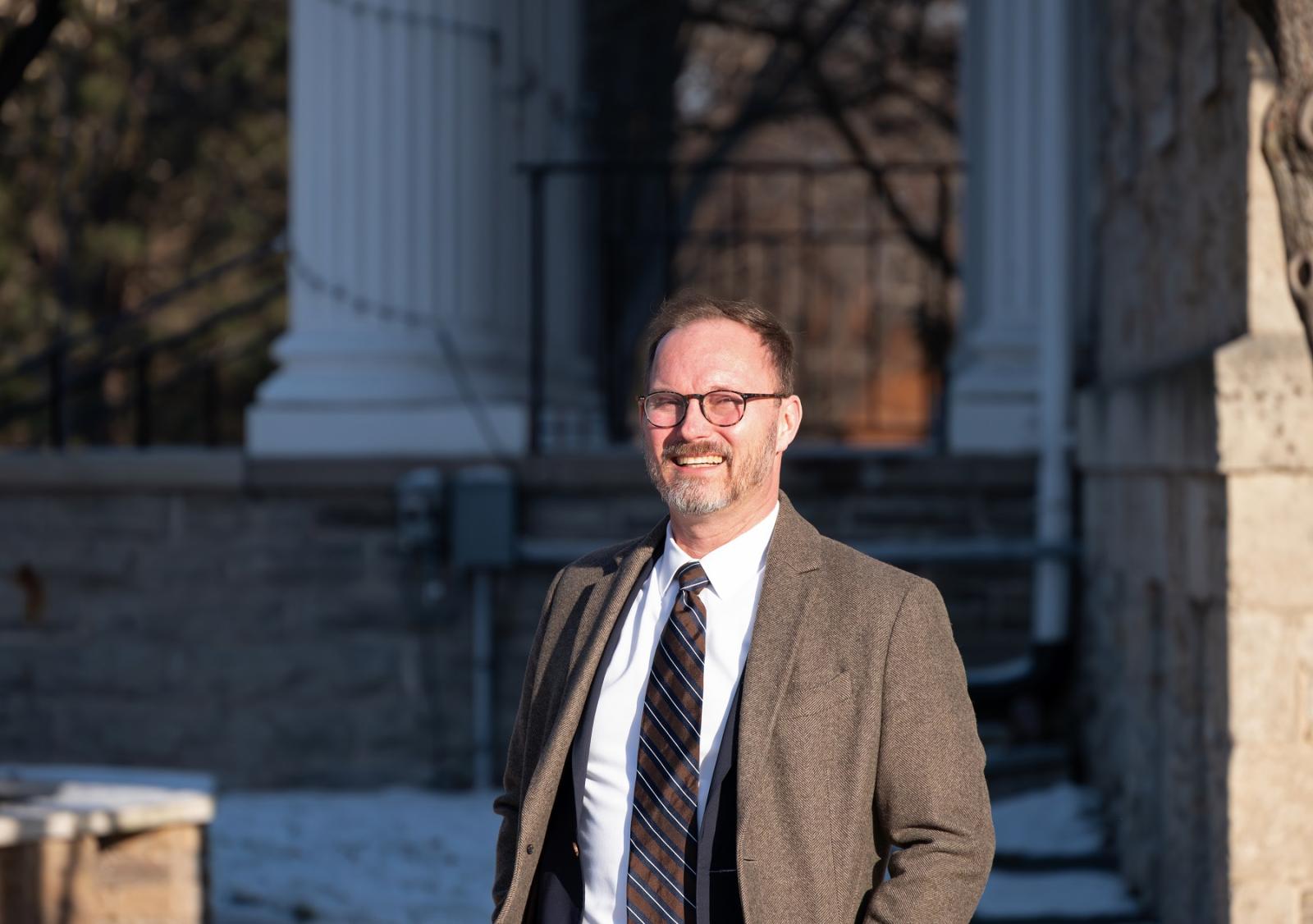 Portrait of Garth Bond standing in front of Main Hall.