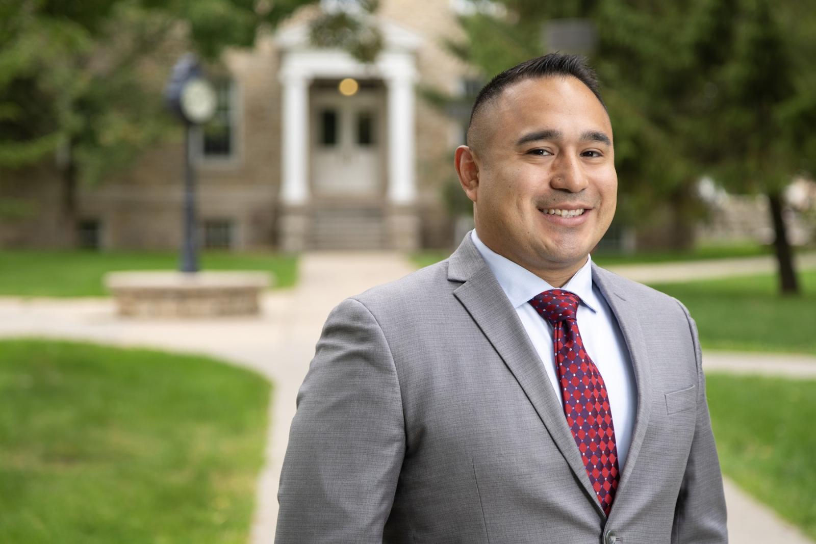 Juan Arguello poses for a portrait on Main Hall Green.