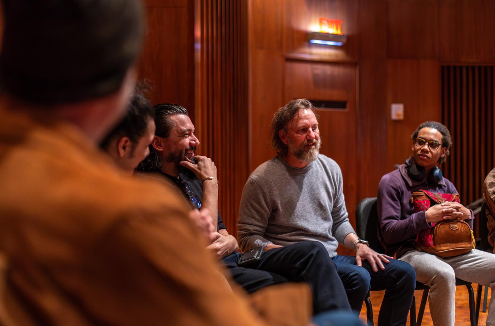 Novelist Michael Smith talks with Lawrence students during a songwriting class.
