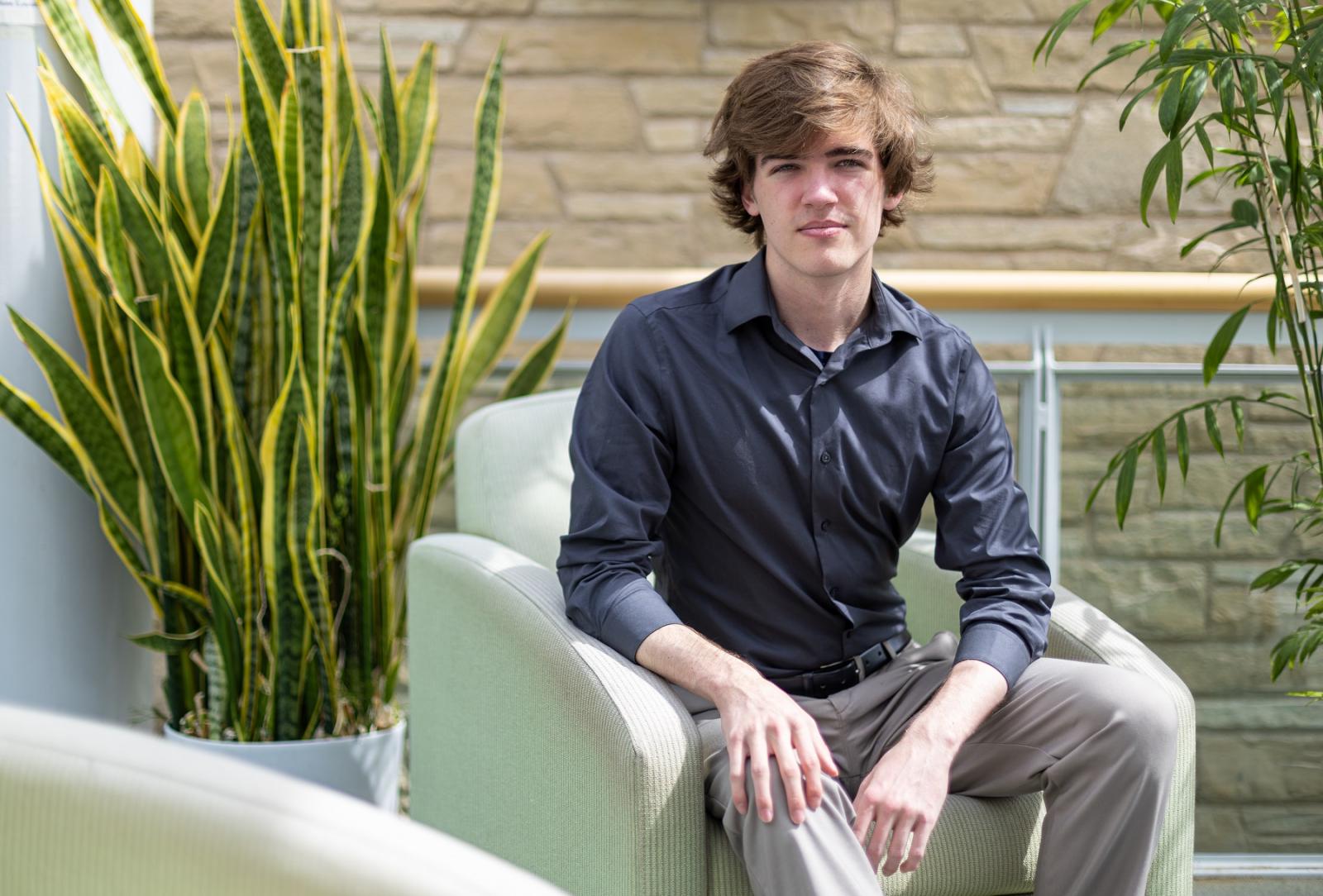 Joseph Carpenter poses for a photo in Steitz Hall of Science.