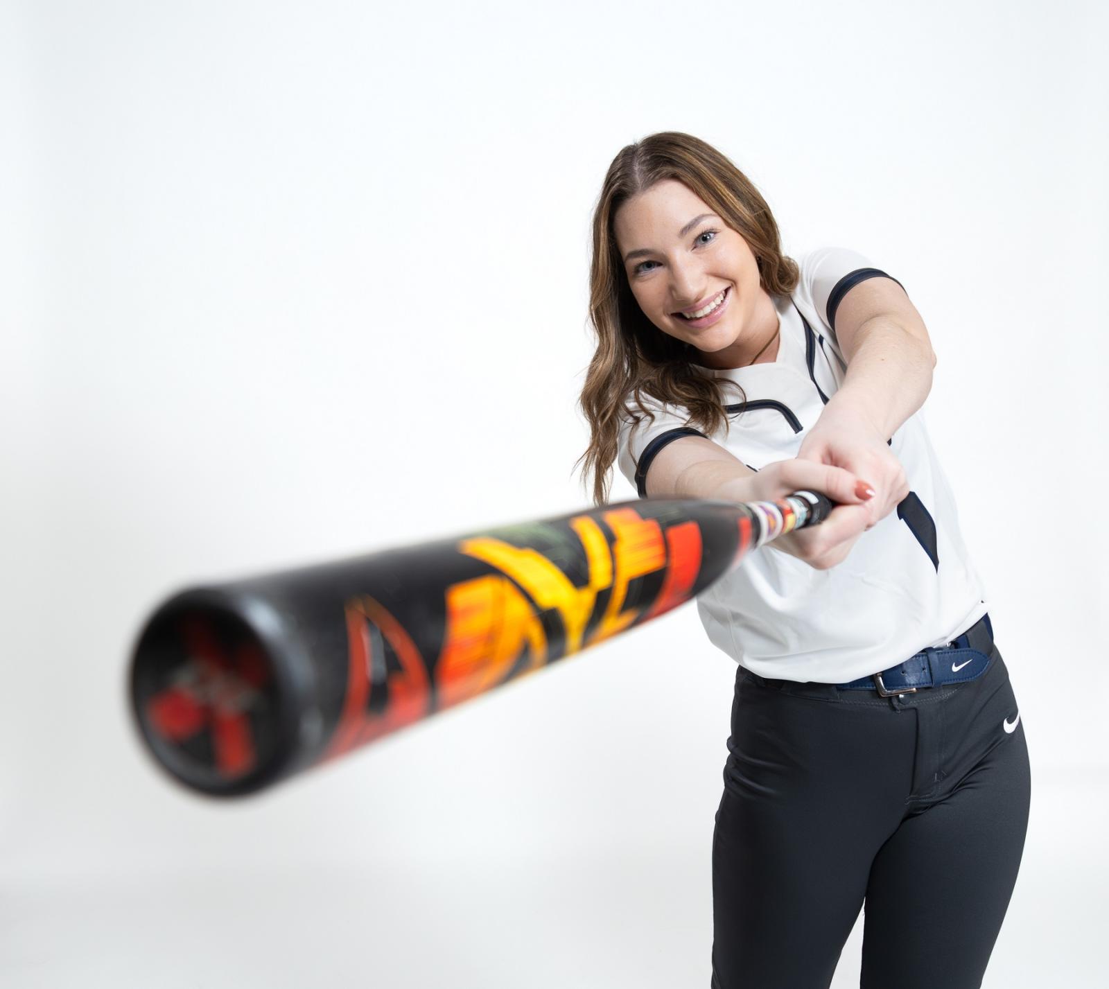 Mattigan Haller swings a softball bat during a media day photo shoot.