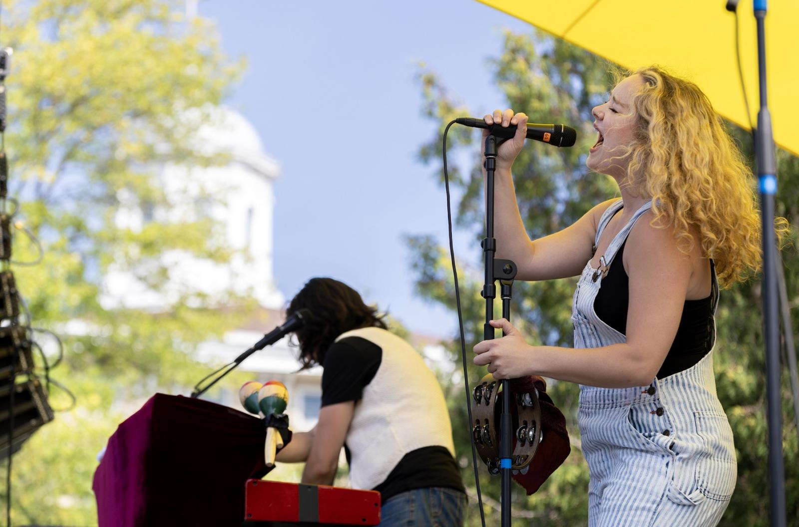 Main Hall cupola is seen in the background as a Mile of Music artist performs on Main Hall Green during the 2023 festival.