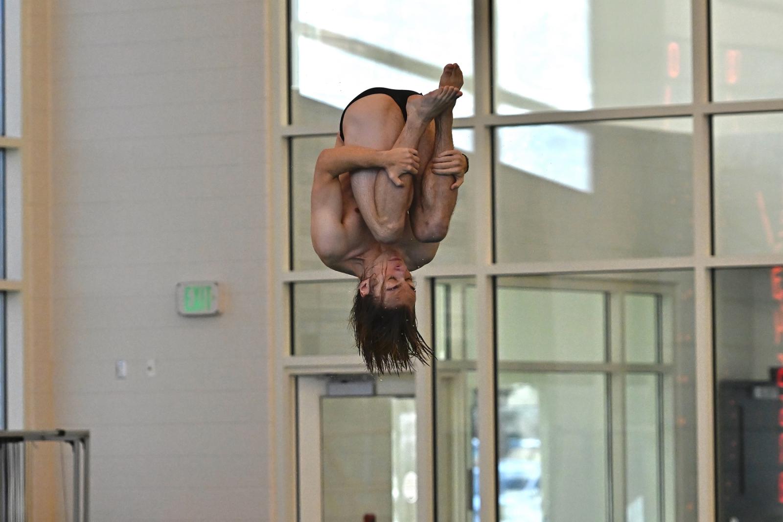 Jackson Bertman tucks in his knees in mid-dive.