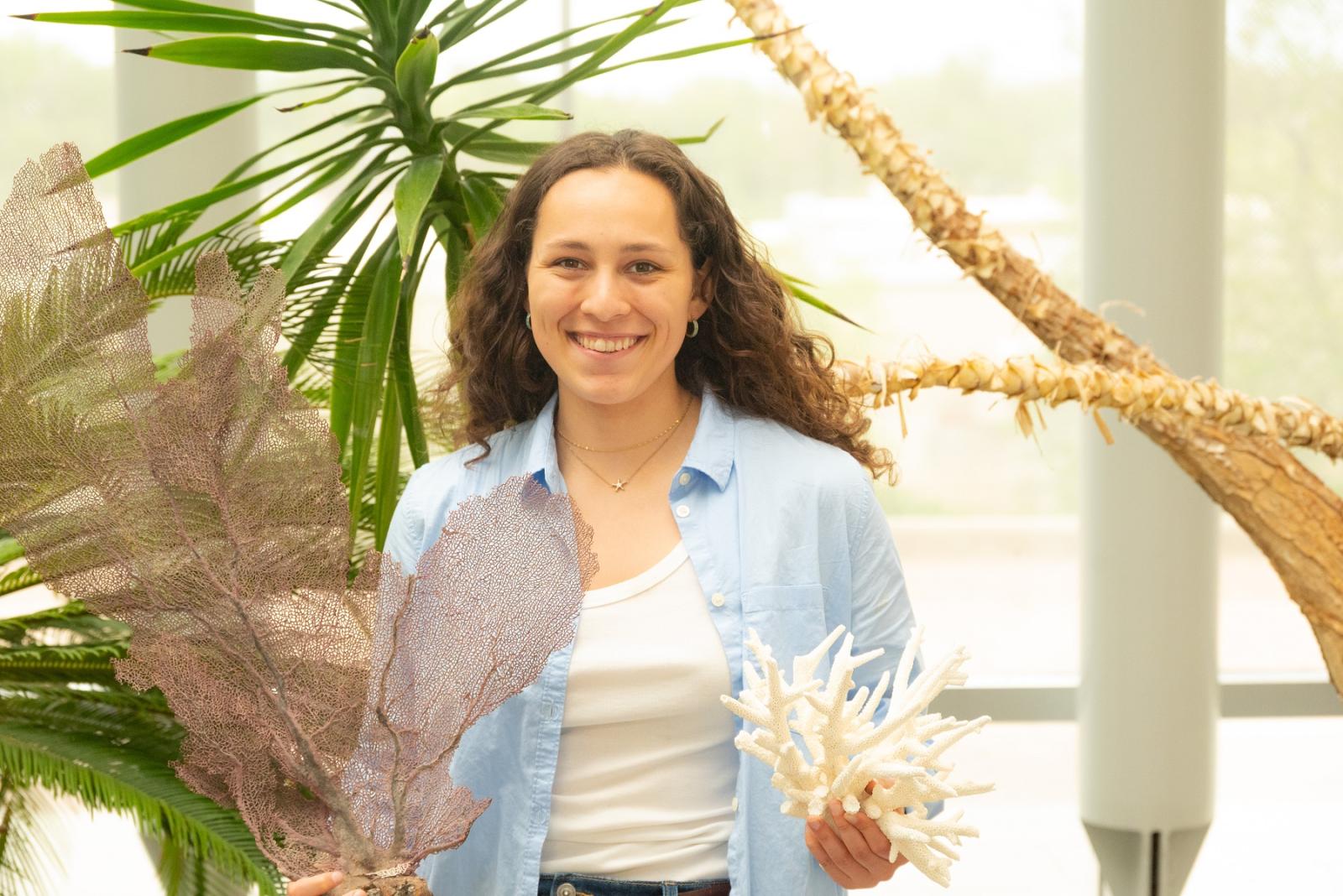 Emma Moya poses with some of the coral samples found in Bonaire.
