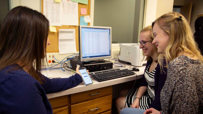 Psychology major students reviewing Carelab, a phone app developed by Lawrence for child emotional development research