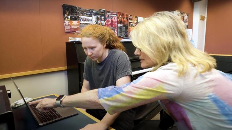 Patty Darling, music composition instructor and jazz ensemble conductor, works with music compostion major on a composition piece