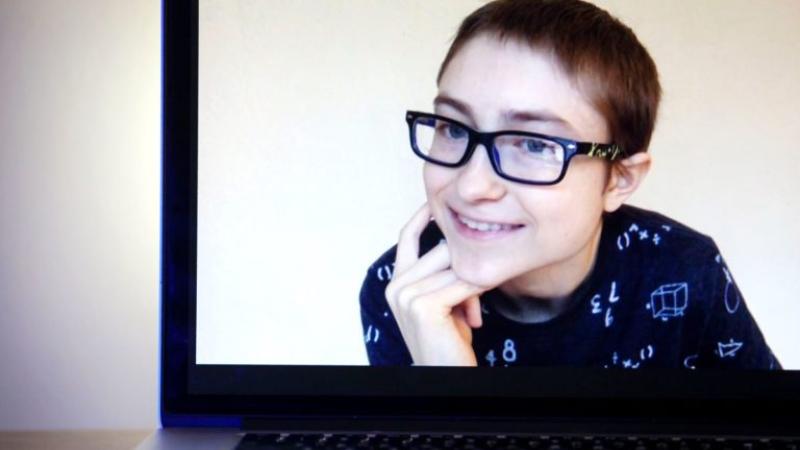 Jojo Maier is shown smiling on a laptop screen.