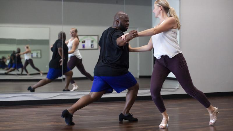 Jesus Smith rehearses with Pamela Cribbs in front of a mirror 