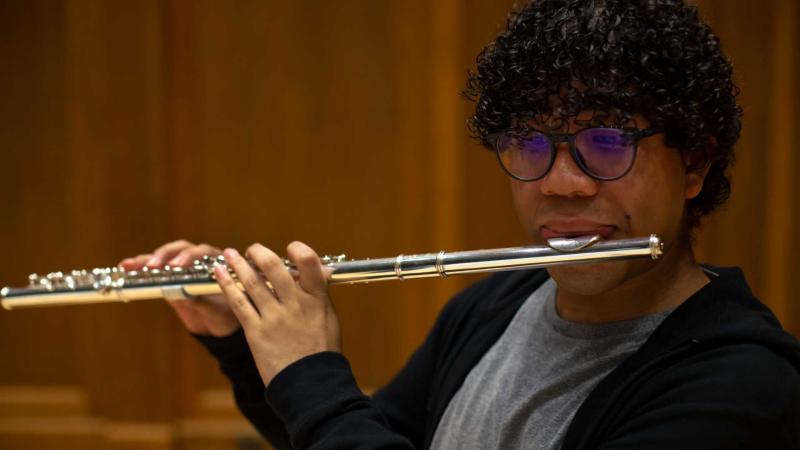Student playing flute during Flute Ensemble rehearsal.