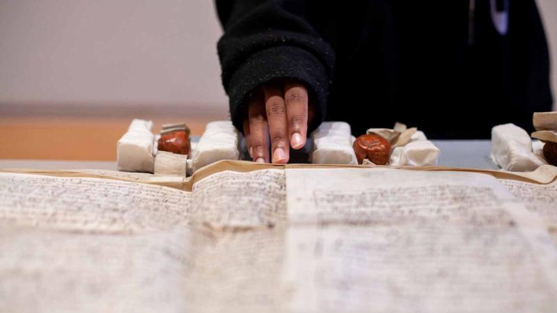 Person examining documents.
