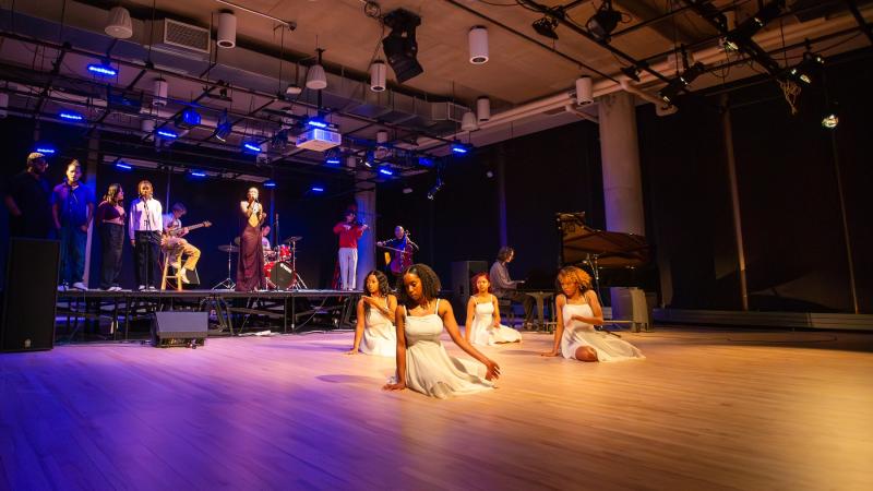Students dance in front of the stage.