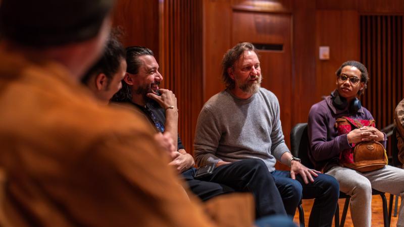 Novelist Michael Smith talks with Lawrence students during a songwriting class.