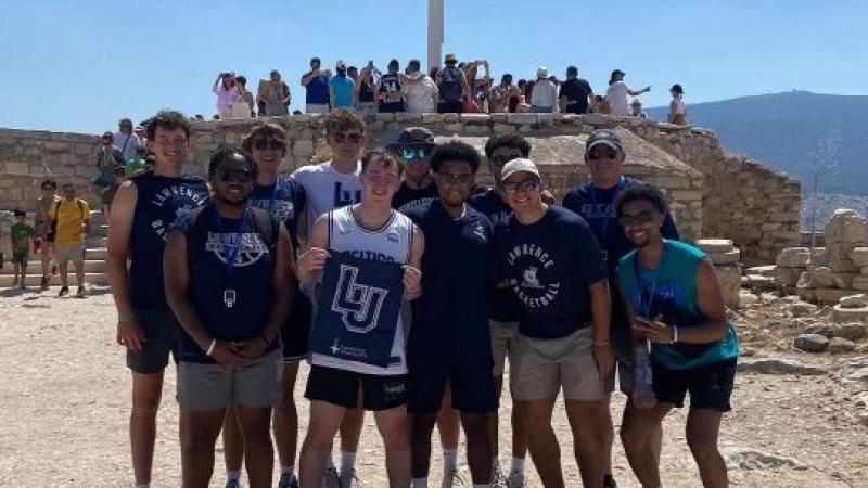 Lawrence basketball players pose with their Lawrence gear during a trip to Greece.