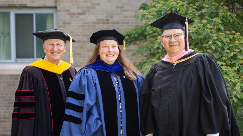 Faculty award winners, dress in regalia, include (from left) Matthew Stoneking, Kelly Culhane, and Matthew Michelic.