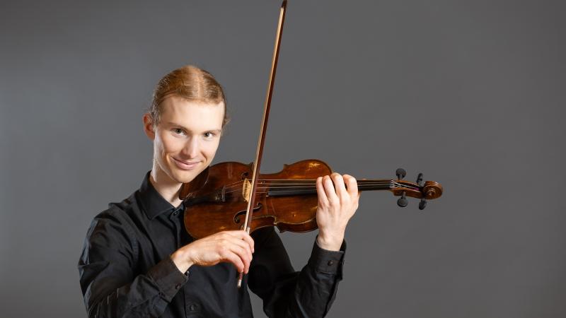 Ben Frueh poses with his violin.