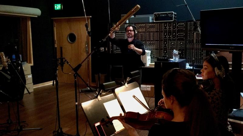 Francis James Ralls ’04 conducts a string ensemble for a recording session at Hans Zimmer’s Remote Control Productions.