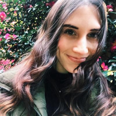 Cheyenne Koscher headshot in front of flowers