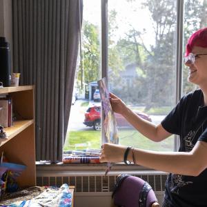 Student prepares to hang a photo